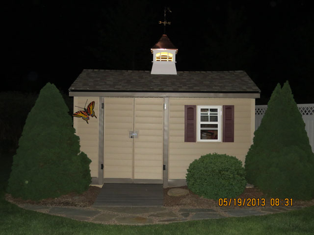 flared charelston cupola on a shed at night