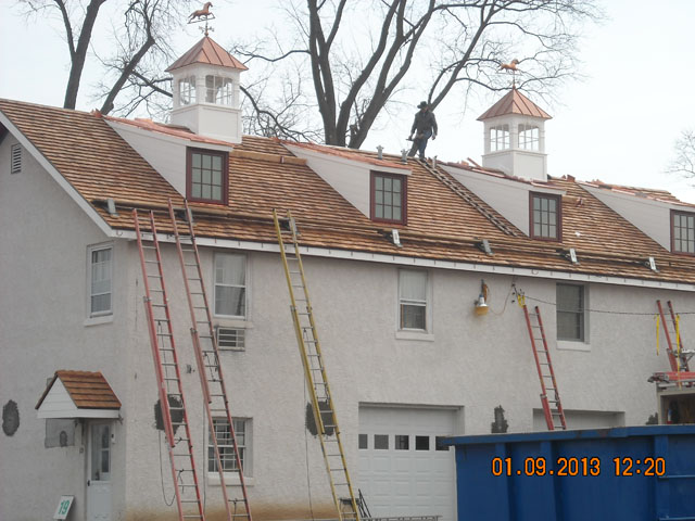 two custom fairfielld cupolas with horse weathervanes on apartment building